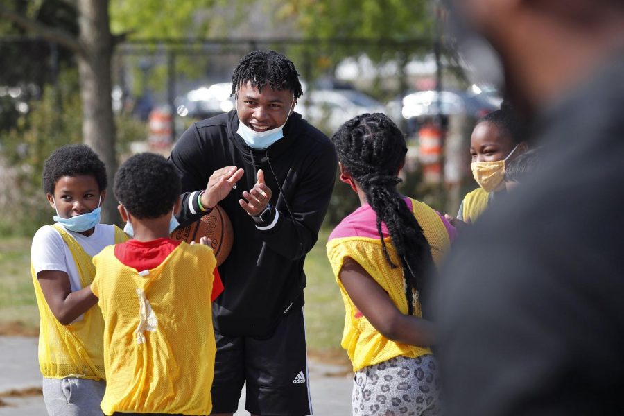 Jayden Epps smiles while coaching kids participating in a free basketball camp at Fairlawn Recreation Center April 8. Epps recently committed to the Illinois basketball program for the upcoming season. 