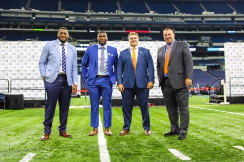 Vederian Lowe, Owen Carney, Doug Kramer and Bret Bielema pose for a photo at Big Ten Media  Days in Indianapolis. The idea of family has become a recruiting tactic for Bielema and his staff, with all three players choosing to return after hearing their pitch.