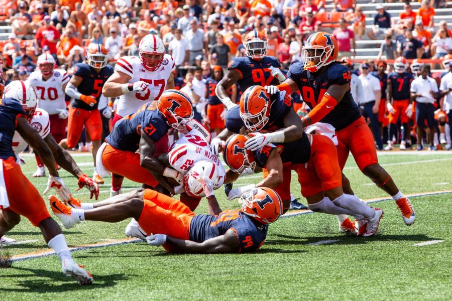 Members of the Illinois football team tackle their Nebraskan opponents during their game Aug. 28, 2021.
