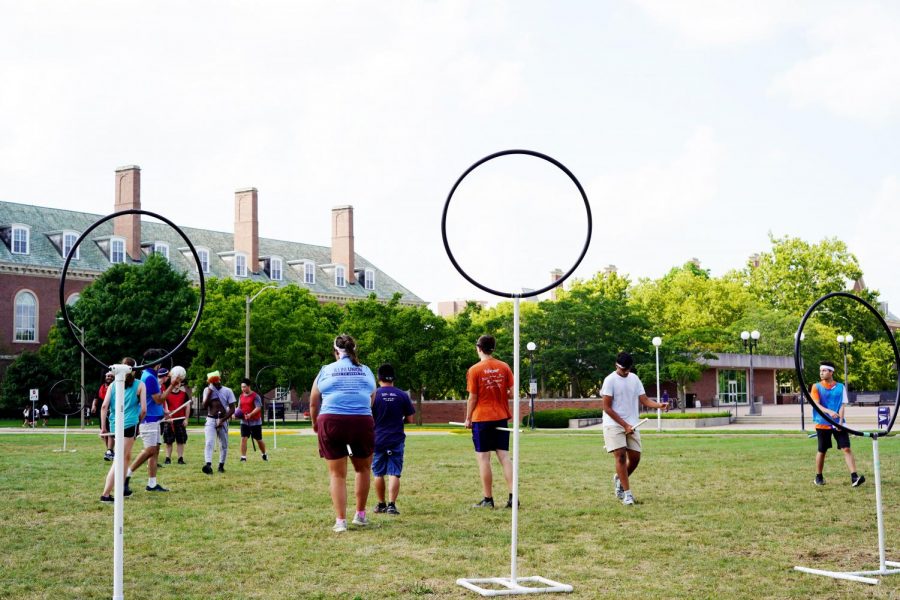 People play Quidditch on the South Quad. The group play together as a community that bonds over Harry Potter.