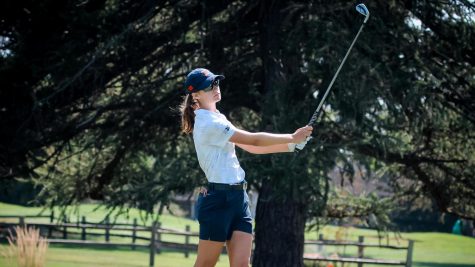 Freshman Lexanne Halama swings at a golf ball at the Wolverine Invitational. The team hopes to improve upon their game at the Schooner Fall Classic. 