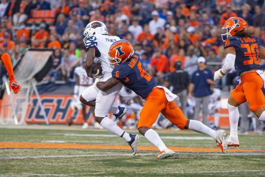 Defensive back Tony Adams tackles his UTSA opponent during their game at Memorial Stadium Sept. 4. The DI sports staff predicts Illinois week 2 matchup with Virginia.