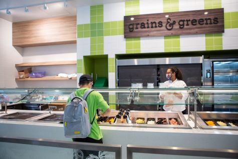 A students picks out what he wants to eat at Illinois Street Residences Grains & Greens station. Vegetarians living in the dorms found that seeing what each dining hall has been serving helps them find a healthy meal to fit their needs.