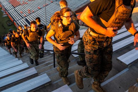 Members of the ROTC Marine Corps program climb the steps of Memorial Stadium on Sept. 9 to honor first responders in 9/11.