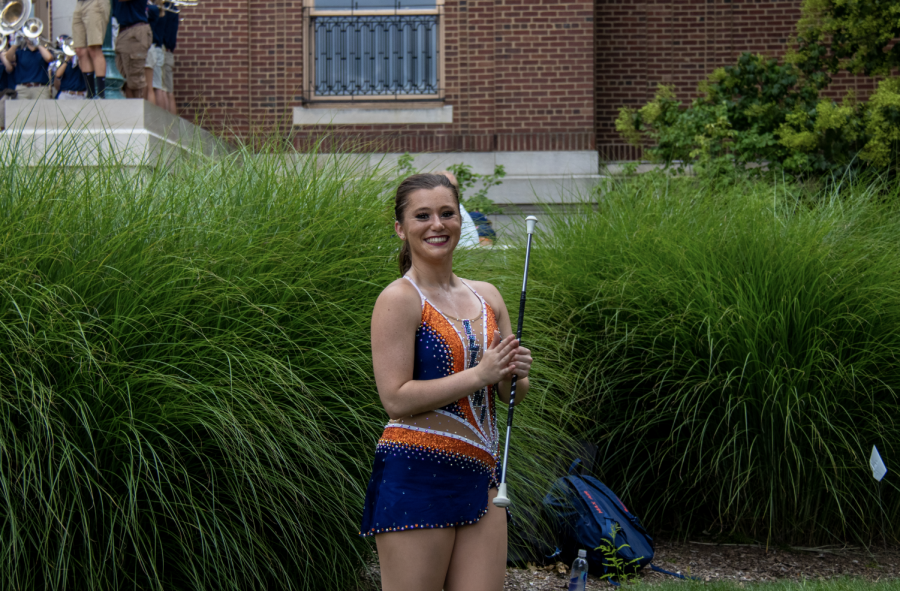 Julia Arciola, junior in LAS, holds her baton on Quad Day while performing with the Marching Illini on Aug. 22. Arciola reflects on her past successes and experience as a baton twirler at the University. 