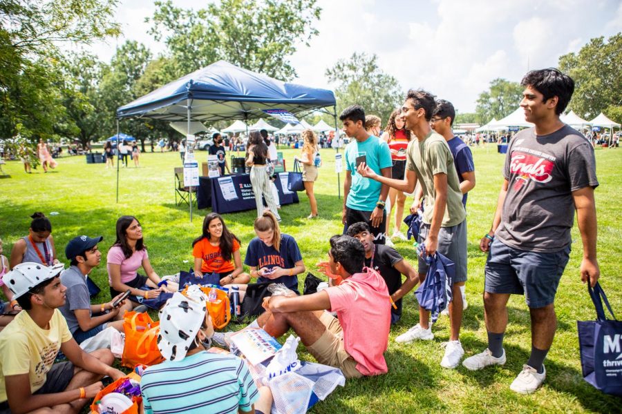 A group of University of Illinois freshman sit in a circle during the Welcome Celebration in Lot 31 after the New Student Convocation on  Aug. 20. The University reported on Wednesday  that the 2021-22 freshmen class is the largest class to be enrolled.