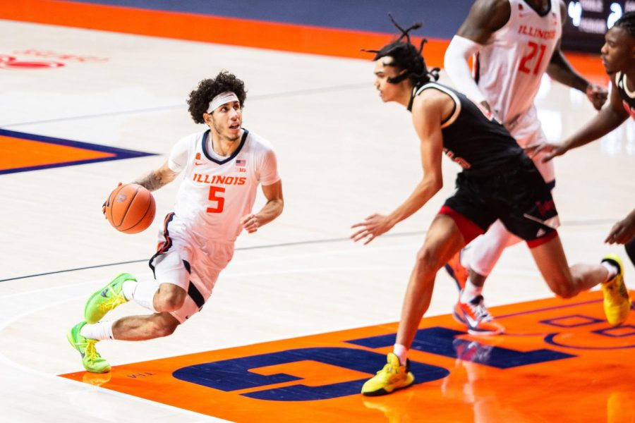 Andre Curbelo dribbles toward the basket during the game against Nebraska Feb. 25. There are three crucial  questions that the Illinois basketball team has yet to answer as they go into their first preseason game on Saturday.