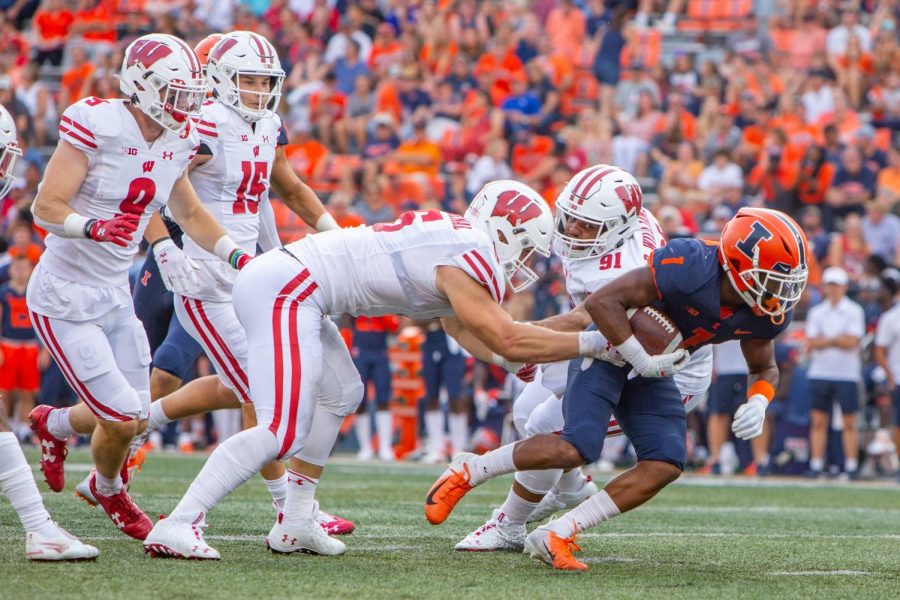 Wide receiver Isaiah Williams breaks through a line of Wisconsin player during the homecoming game Oct. 9. The Illini sports staff predicts the outcome of todays game against Rutgers. 