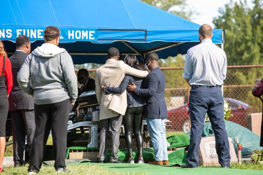 Carmen Day, mother of the late Jelani Day, stands in front of his casket embracing family members during his funeral service at the Spring Hill Cemetery in Danville on Oct. 19. It is important to utilize your voice in seeking justice for Jelani Day from authority figures.