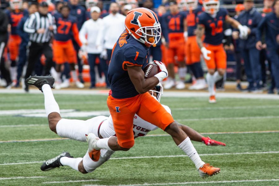 Isaiah+Williams+shakes+off+a+tackle+en+route+to+a+52-yard+touchdown+in+the+first+half+against+Rutgers+on+Saturday.+The+Illini+fell+to+the+Scarlet+Knights%2C+20-14%2C+after+getting+shut+out+in+the+second+half.