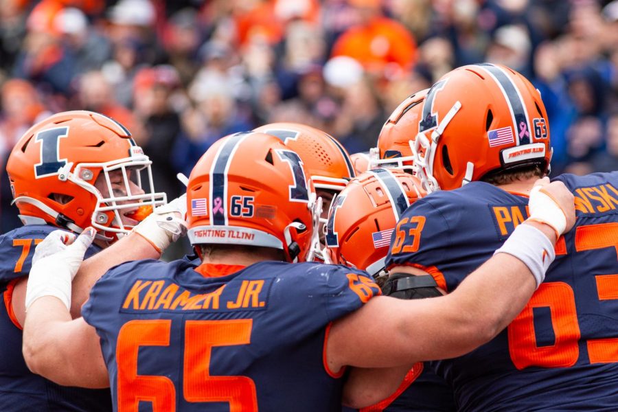 The Illinois offensive line huddles during the game against Rutgers at Memorial Stadium on Saturday. Penalties proved critical in the Illinis 20-14 loss.