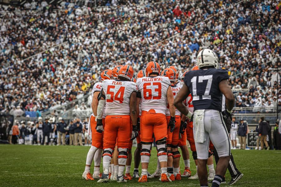 The Illinois offensive line huddles during the game against No. 7 Penn State on Saturday. The offensive line proved pivotal in the Illinis historic nine-overtime win despite a few key injuries. 