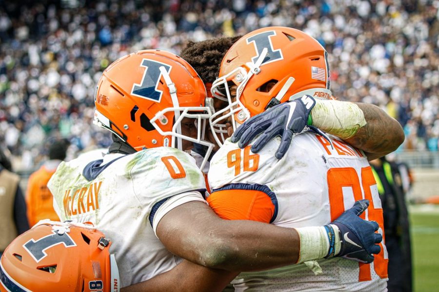 Running back Josh McCray (0) celebrates with defensive lineman Roderick Perry II the teams victory against Penn State Oct. 23. The long battle was won with strong performances from the offensive linemen and running backs. 
