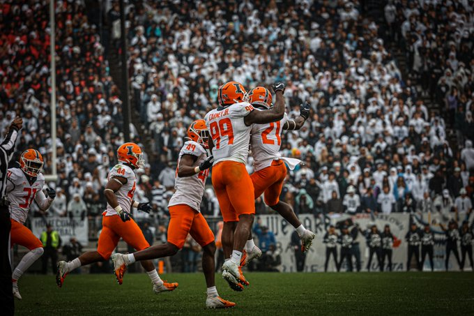 Illinois Owen Carney Jr. (99) and Jartavius Martin celebrate during the game against Penn State on Saturday. The Illini defense and running backs were pivotal in the Illinis record-breaking upset over the No. 7 Nittany Lions in Happy Valley.