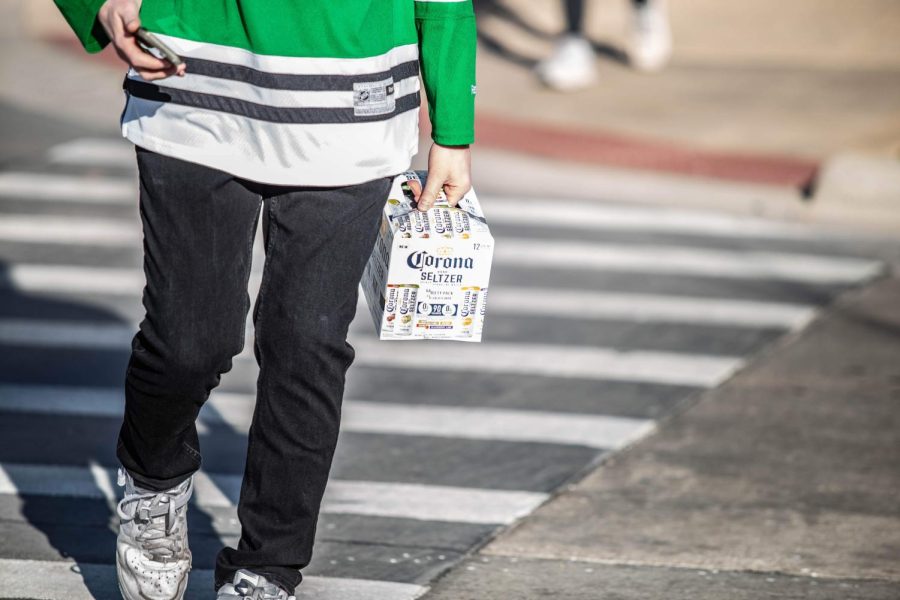 Student carries a a pack of seltzers to a party on Mar 6, 2020. Columnist Noah Nelson gives some partying advice in having a safe and great night out.  
