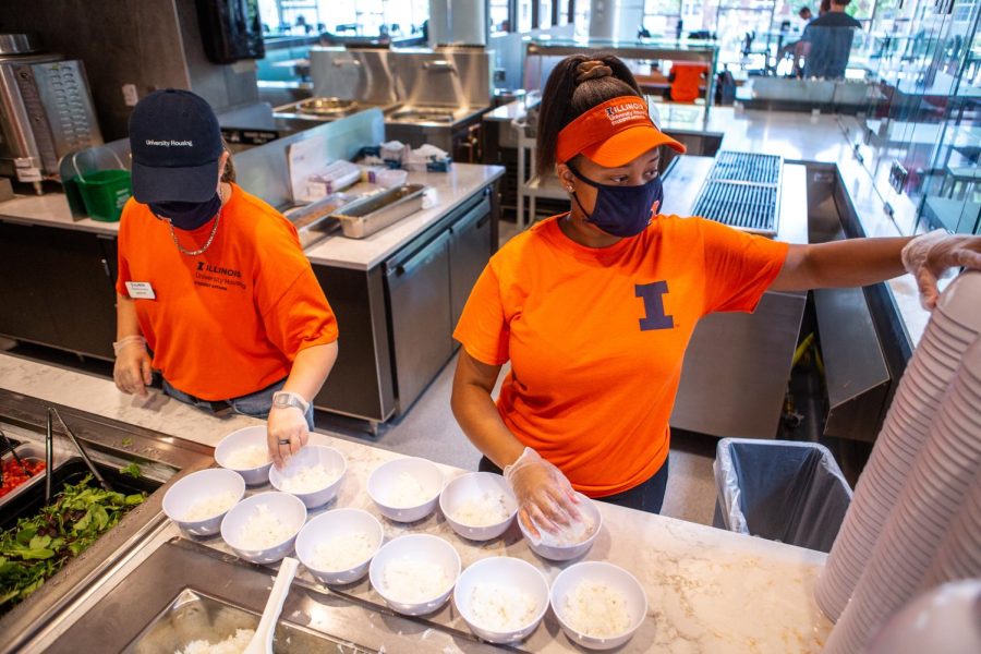 Two dining hall employees pack bowls of rice at the ISR dining hall on Aug. 27. The University is struggling to keep people employed because of the student labor shortage.