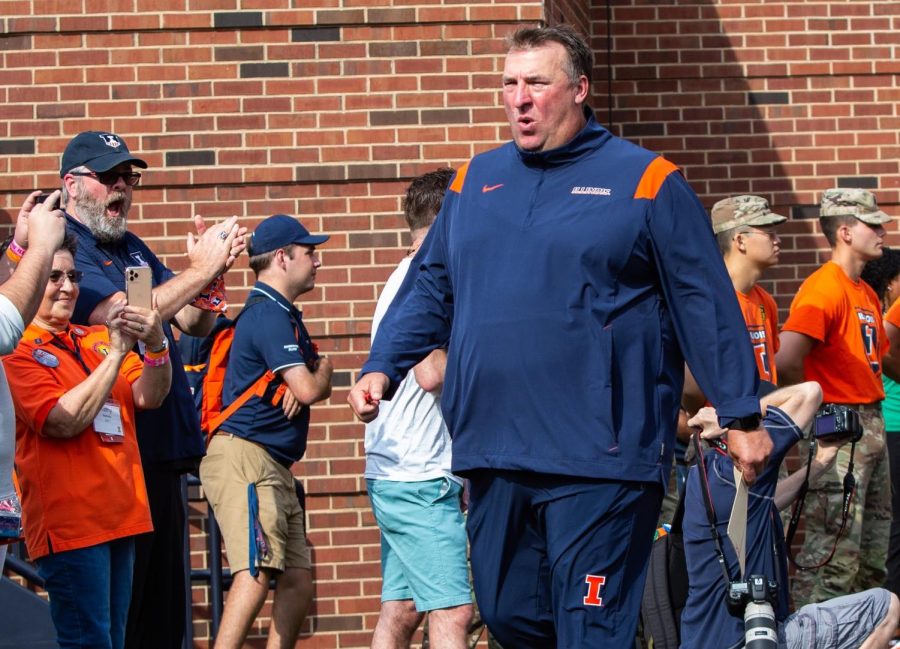 Illinois head football coach Bret Bielema walks onto the field at Memorial Stadium before the game against Wisconsin on Oct. 9. Bielema has focused on in-state recruiting in hopes of a brighter future for the Illini.