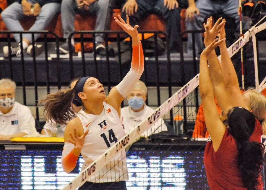 Hitter Jessica Nunge jumps and attempts to tip the ball over to Nebraskas side on Nov. 4. The Illini will host their next match against Minnesota at Huff Hall this weekend. 