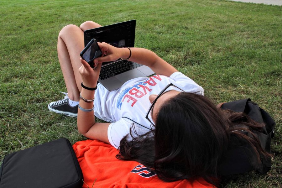 Sadeen AlHalabi, student in FAA, uses her phone on the Main Quad on Sept. 3, 2019. Optometrist Dr. Amber Cumings says that too much screen time strains your eyes health.