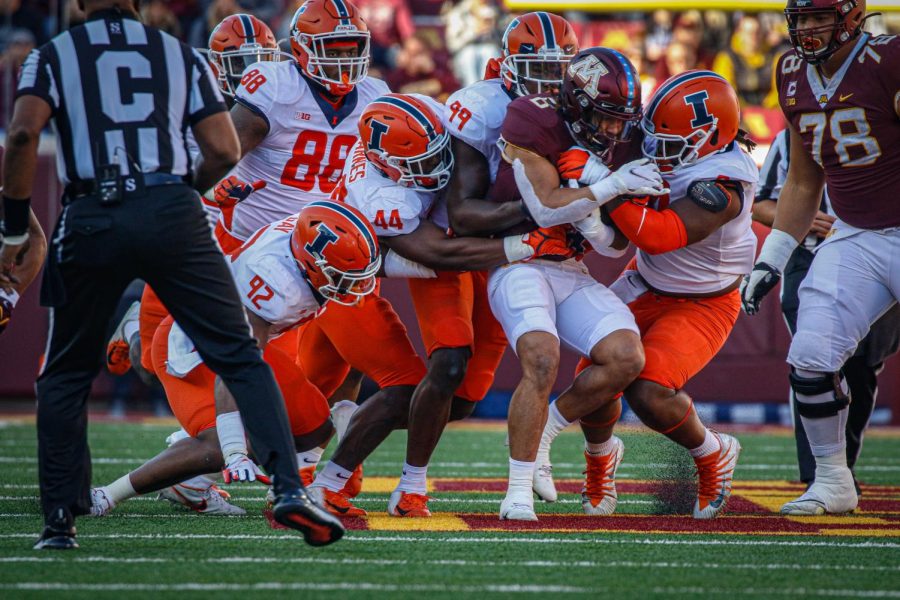 The Illinois defense surrounds Minnesota running back Ky Thomas in the first half at Huntington Bank Stadium in Minneapolis. The Illini defense dominated from start to finish, playing a big part in the teams 14-6 upset over the No. 20 Golden Gophers.