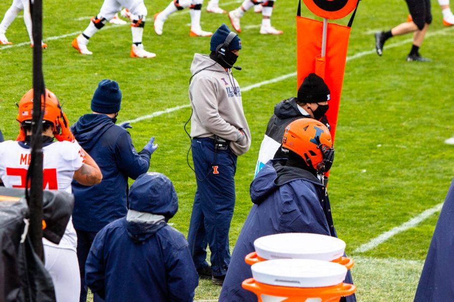 Former Illinois head coach Lovie Smith walks along the sidelines before the game against Northwestern at Ryan Field on Dec. 12. Columnist Carson Gourdie argues that Illinois needs to knock Pat Fitzgerald down a notch for in-state success.