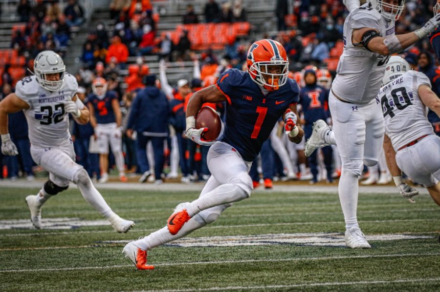 Illinois+wide+receiver+Isaiah+Williams+runs+with+the+ball+during+the+game+against+Northwestern+at+Memorial+Stadium+on+Saturday.+The+Illini+offense+excelled+in+every+sense%2C+using+a+balanced+aerial+and+ground+game+to+dominate+the+Wildcats+and+secure+a+33-point+win.