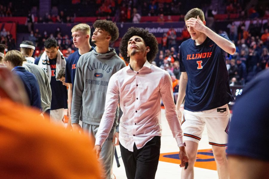 Andre Curbelo walks on the sideline in street clothes during Illinois 83-79 loss to No. 11 Arizona on Dec. 11 at State Farm Center. The Illini has really missed his personality and spirit on the court, sports on-air editor Josh Pietsch writes.