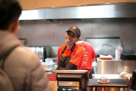 Kamille Thompson serves a customer at Panda Express on Green Street on Dec. 1, 2017. Panda Express is reopening after closing during the pandemic.