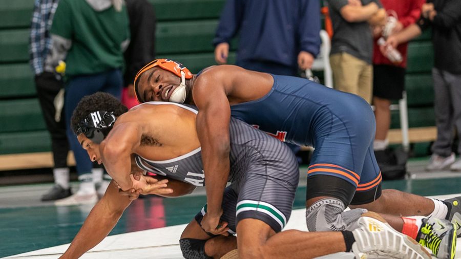 Wrestler DJ Shannon wrestles an opponent during a match. The Illini wins matches against Chattanooga and SIUE and will be back in action on Dec. 29. 