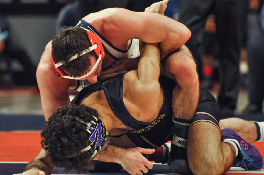 Wrestler Dylan Duncan takes down his Northwestern opponent during his match on Saturday. Duncan won his his match 9-2, but the Illini lost against Northwestern 13-26. 