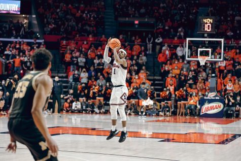 Trent Frazier attempts a 3-pointer during No. 25 Illinois mens basketballs game against Michigan at State Farm Center on Friday night. Fraziers 16 second-half points were key in the Illinis 68-53 win over the Wolverines.