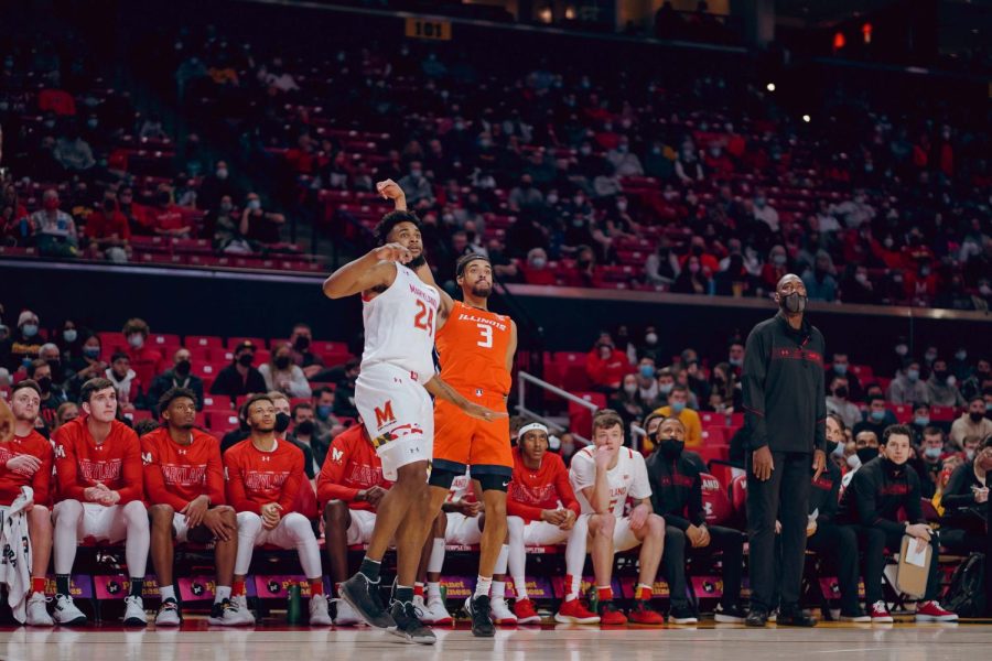 Jacob Grandison shoots a 3-pointer over Terrapin guard Donta Scott during Illinois game against Maryland on Friday night in College Park, Maryland.