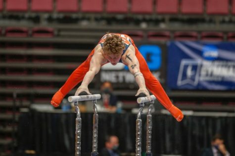 Gymnast Logan Myers performs on the parallel bars during the NCAA Championship Finals on April 17. The Illini began their season with a third place finish at the Windy City Invitational on Saturday. 