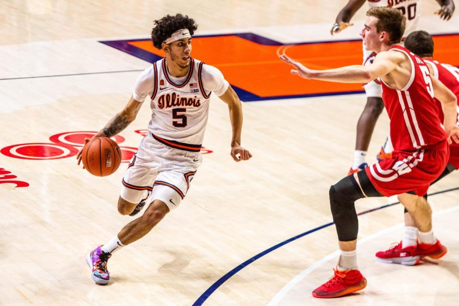 Illinois guard Andre Curbelo dribbles while being guarded by Wisconsin forward Tyler Wahl during the game on Feb. 6 in Champaign. Curbelo is expected to return after a two-game absence as the No. 18 Illini welcome the No. 11 Badgers to State Farm Center on Wednesday night.
