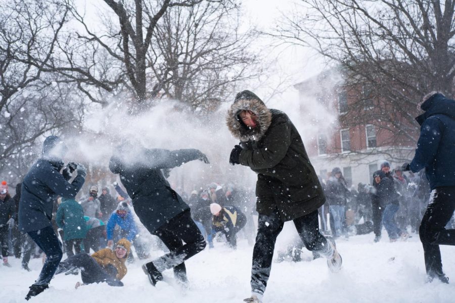 Students runs through the middle of the snowball fight on the quad on Thursday. 