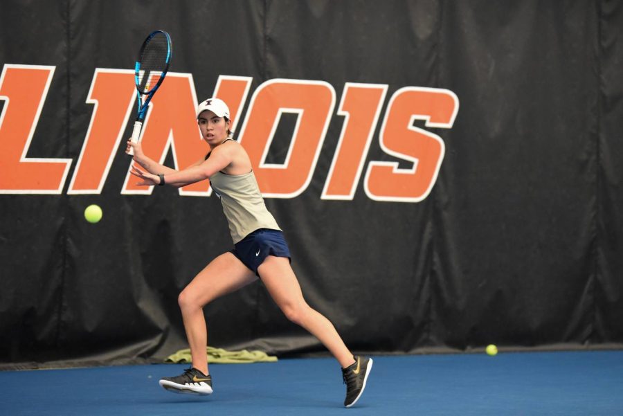 Sophomore Kate Duong performs a forehand stroke to send the ball back to the opposing team. Duong has made a significant stride within her career in tennis by earning a spot in the top courts within her second season.
