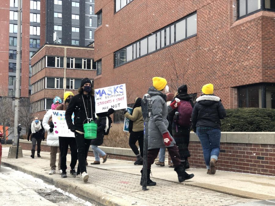 GEO members protest outside of the Swanlund Administration Building on Wednesday. The protest was in response to the Universitys policy on lifting mask mandate. 