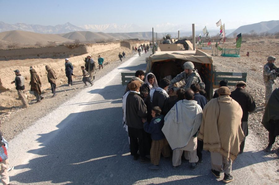 Local villagers receive humanitarian aid from the Bagram Provincial Reconstruction Team in Afghanistan in 2008. Senior columnist Eddie Ryan argues that President Bidens misuse with the Afghan funds is not the right course of action. 