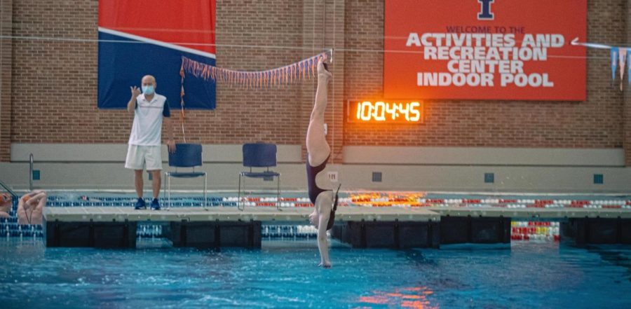 Sophomore diver Brooke Michael dives into the pool during a meet at the ARC. Michaels had an average score of 6.69 at the invitational on Saturday. 