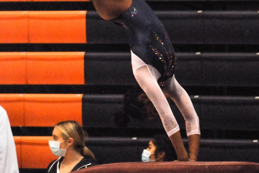 Gymnast Arayah Simmons practices before her vault event during the competition against Minnesota on Sunday. Simmons scored a new personal high for her vault event with a 9.850. 