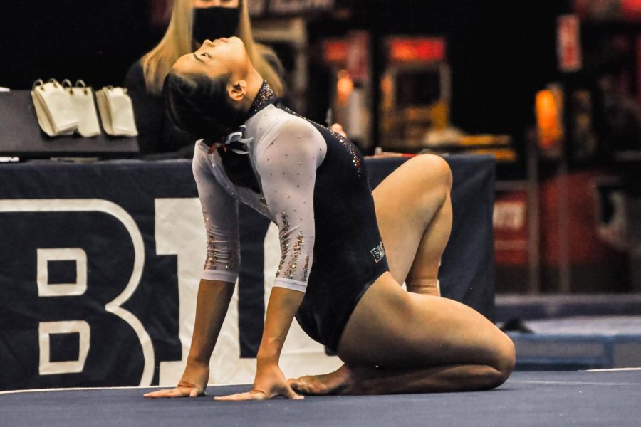 Gymnast Mia Takekawa begins her floor exercise routine during the competition against Minnesota on Feb. 6. Takekawa scored a team high on bars, but the Illini lose against Michigan State. 