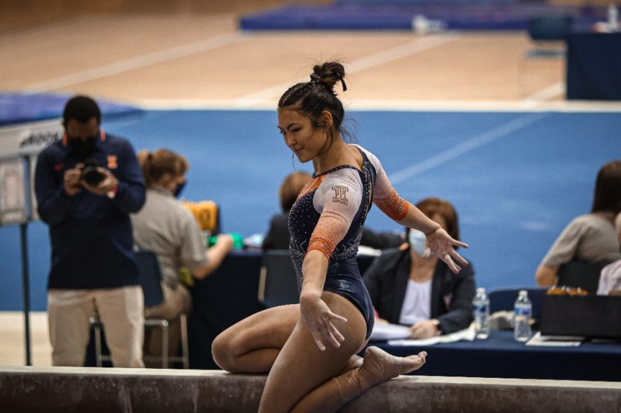 Gymnast Mia Takekawa does her performance for her beams event against Michigan on Feb 21, 2021. Takekawa set career highs for her events in bars and vault, but the Illini lose to Nebraska 195.375-195.500.