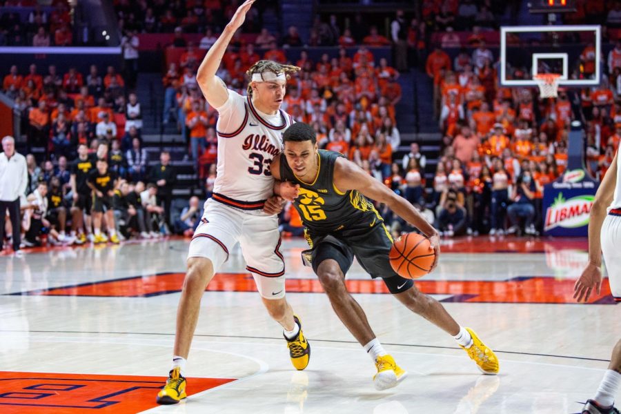 Sophomore forward Coleman Hawkins plays defense on Iowa forward Kris Murray in the second half of the Illinis 74-72 win on Sunday at State Farm Center. Hawkins played arguably his best game of the year, scoring nine points, grabbing 11 rebounds and playing good defense on Murray.