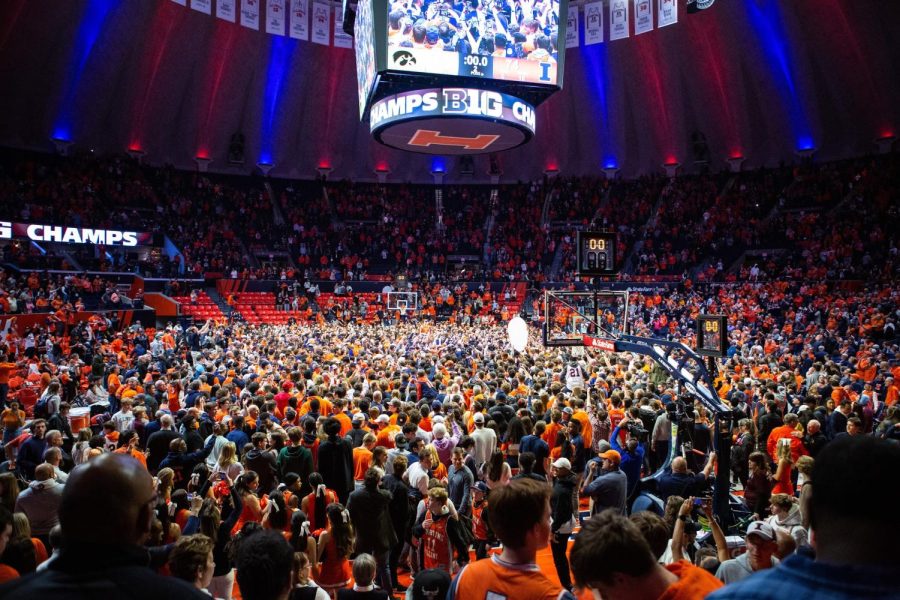 Illini fans celebrate on the court after No. 20 Illinois beat No. 24 Iowa to earn a share of the Big Ten regular-season title. The championship is the programs first since 2005.