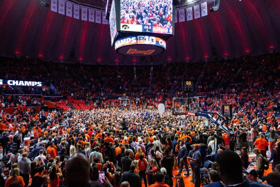 Illinois fans storm the court at State Farm Center after the team pulled off a 74-72 win against Iowa on Sunday. 