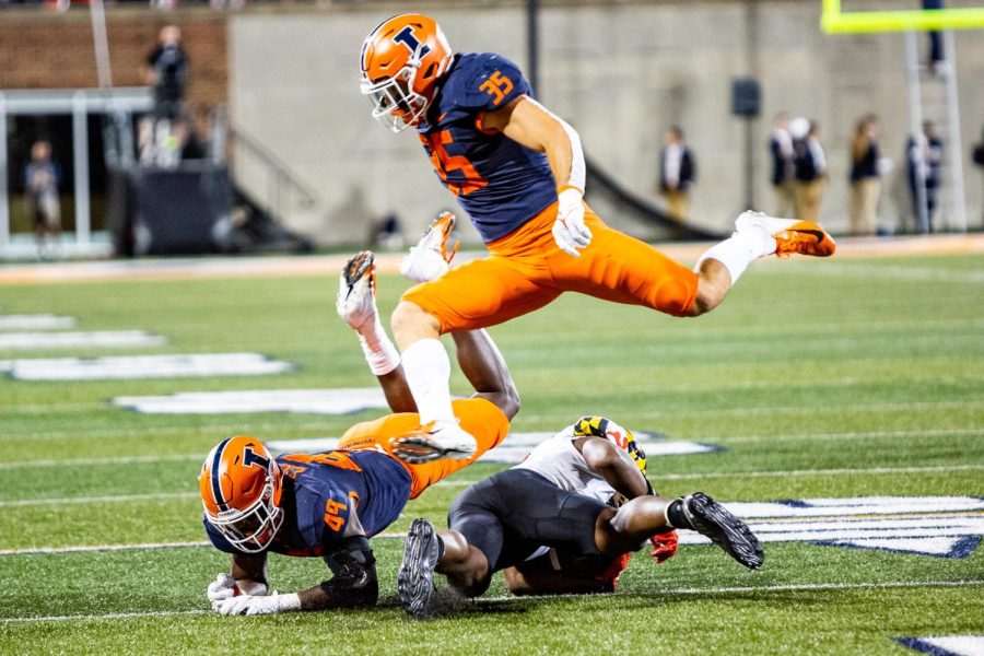 Linebacker Jake Hansen makes a leap over the players who have fallen over on the field on Sept. 18 against Maryland.