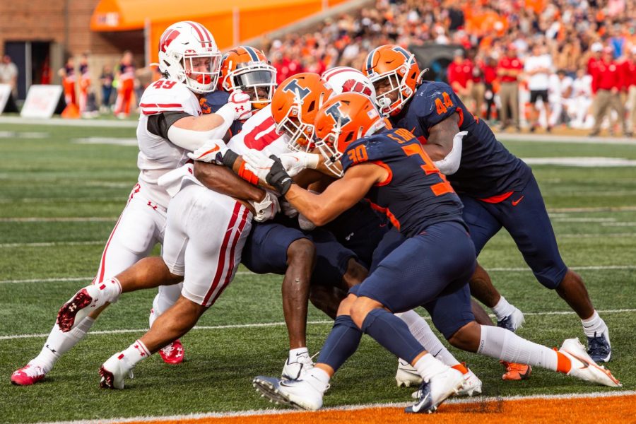 The Illini defensive linemen push Wisconsin away from the end zone during the Homecoming game on Oct. 9. Sports on-air editor, Josh Pietsch, provides insight on key players to look out for during the Spring Game on Thursday. 