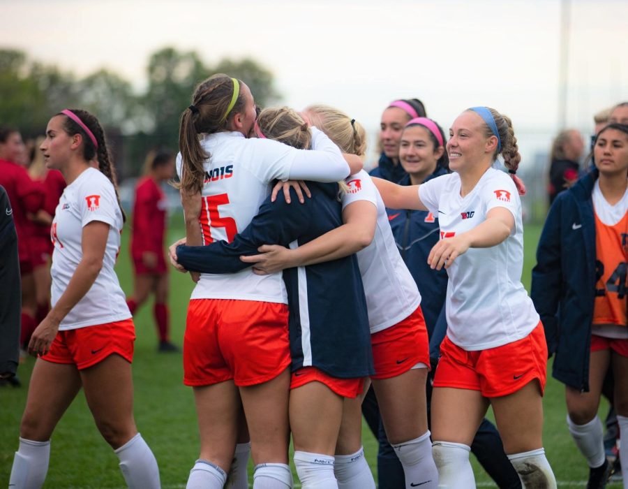 Illini soccer team athletes embrace each other after the senior day game on Oct. 23. The Illini soccer athletes dominated matches against Illinois State and Indiana on Saturday. 