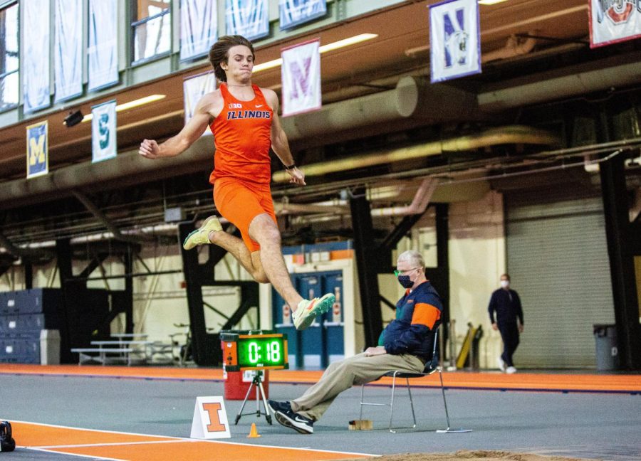 Multi-Event+Aidan+Ouimet+takes+a+leap+into+the+sand+pit+for+the+long+jump+event+during+the+track+field+invite+on+Jan.+21.+Ouimet+recently+set+new+personal+records+in+six+categories+as+well+as+surpassing+the+previous+decathlon+record+held+by+the+University.