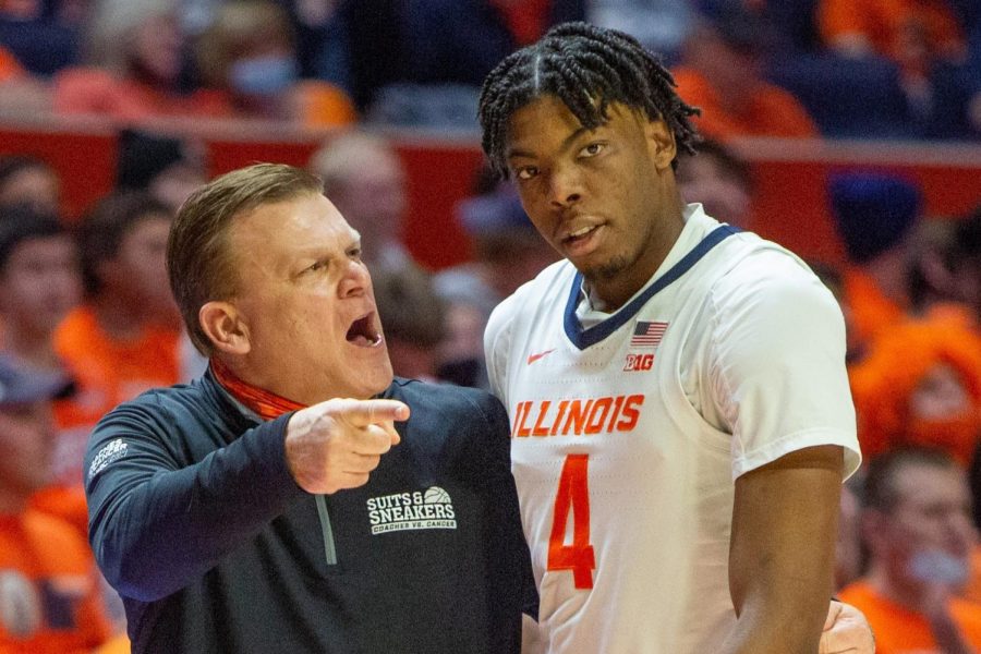 Junior froward Omar Payne talks with head coach Brad Underwood during the game against Michigan on Jan. 25. Payne has announced on social media that he has entered the transfer portal on Saturday. 